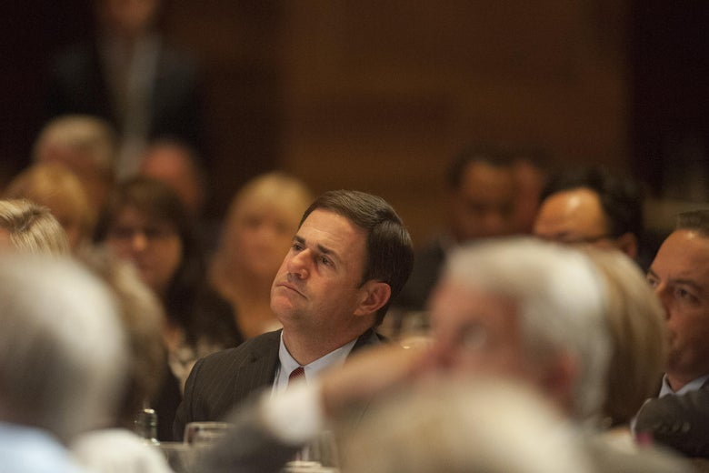 SCOTTSDALE, AZ - MAY 14: Arizona Gov. Doug Ducey listens as former Florida Gov. Jeb Bush speaks at a dinner during the Republican National Committee Spring Meeting at The Phoenician May 14, 2015 in Scottsdale, Arizona. Bush, brother of former President George W. Bush and son of former President George H.W. Bush, is widely expected to run for the Republican nomination for president in 2016. (Photo by Laura Segall/Getty Images)